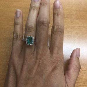 emerald and diamond halo ring in 14k white gold